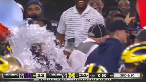Michigan coach Jim Harbaugh avoids Gatorade bath after beating Washington Huskies in College Football Playoff national championship game.